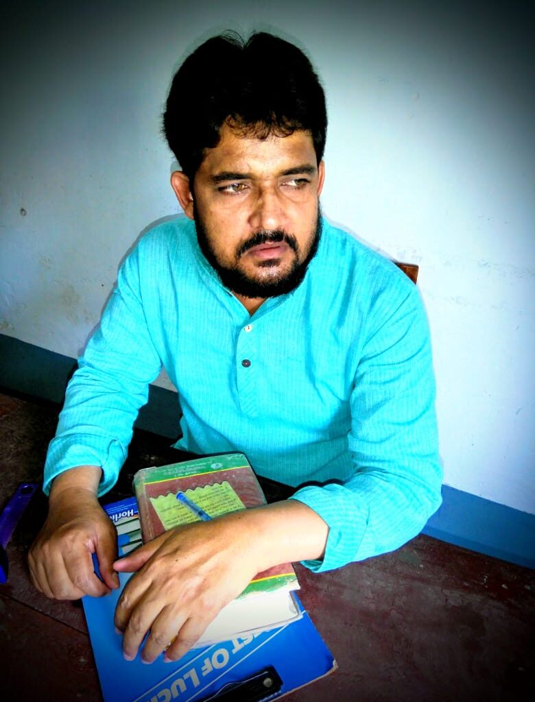 Person sitting with books and notebook.